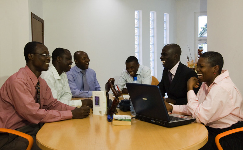 Individuals sitting around the table and having a cordial discussion