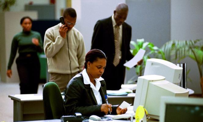 A woman is working on the computer.